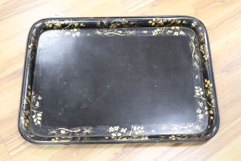 A large papier mache gilt-decorated tray and a 1930s carved oak Canterbury, with double rattan sides